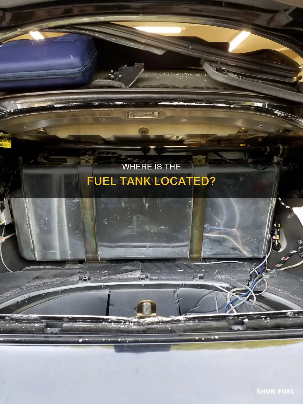 is fuel tank located in front of rear wheels